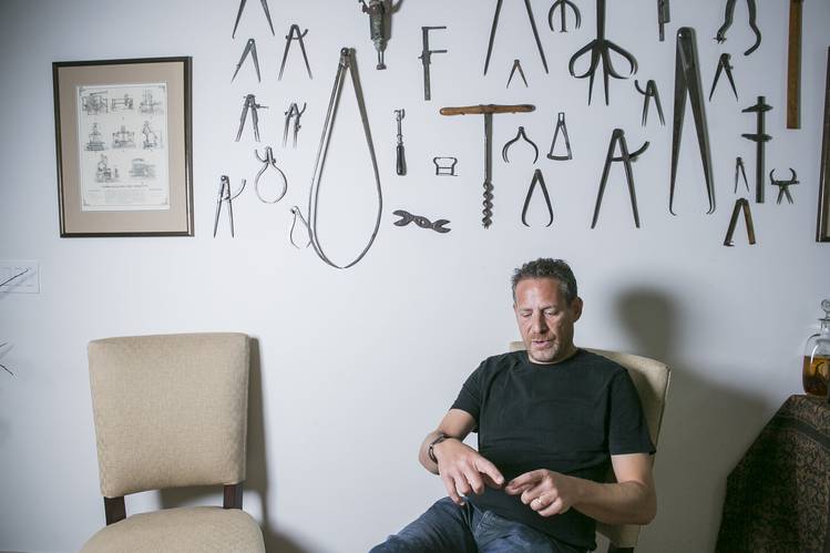 The walls of Mr. Dubno’s living room feature a display of his father’s first tool collection.